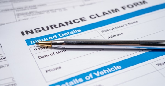 insurance claim form with pen