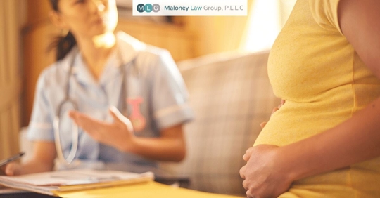 pregnant woman speaking with midwife