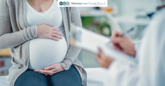 pregnant woman talking with a doctor